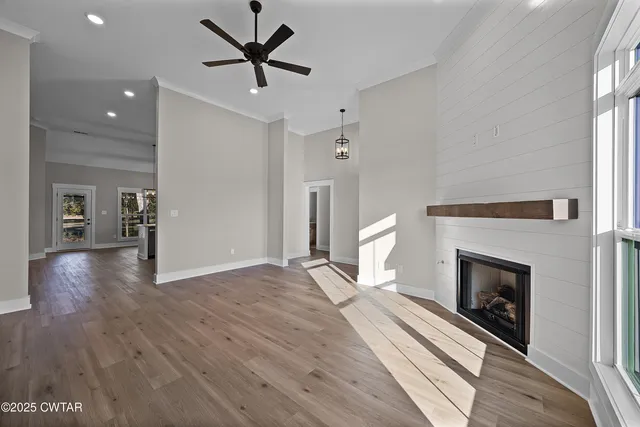 a view of a livingroom with a fireplace and wooden floor
