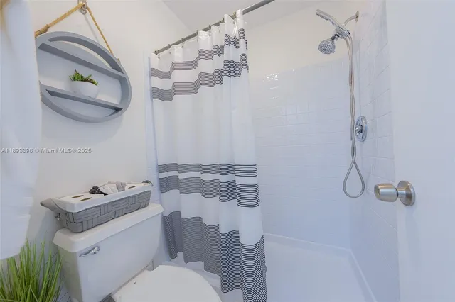 a bathroom with a sink toilet and a mirror