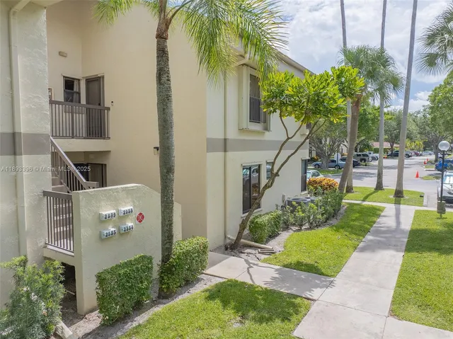 a view of backyard with outdoor seating and plants