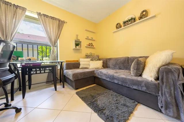 a en suite bathroom with a granite countertop sink and a mirror