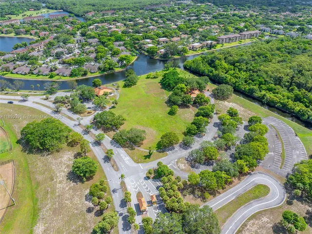 an aerial view of a house with a garden and lake view