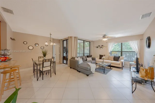 a hallway with painting on the wall and a window