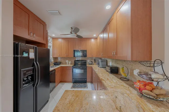 a kitchen with stainless steel appliances granite countertop a refrigerator stove and oven