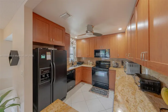 a living room with furniture a large window and a flat screen tv