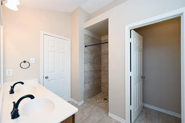 a bathroom with a shower and a sink