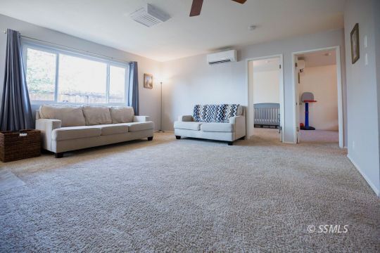 122 South Valley Street Ridgecrest, CA 93555 - Photo 7 of 26 a living room with furniture and a large window