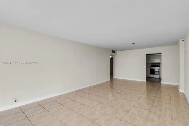 a view of an empty room with closet