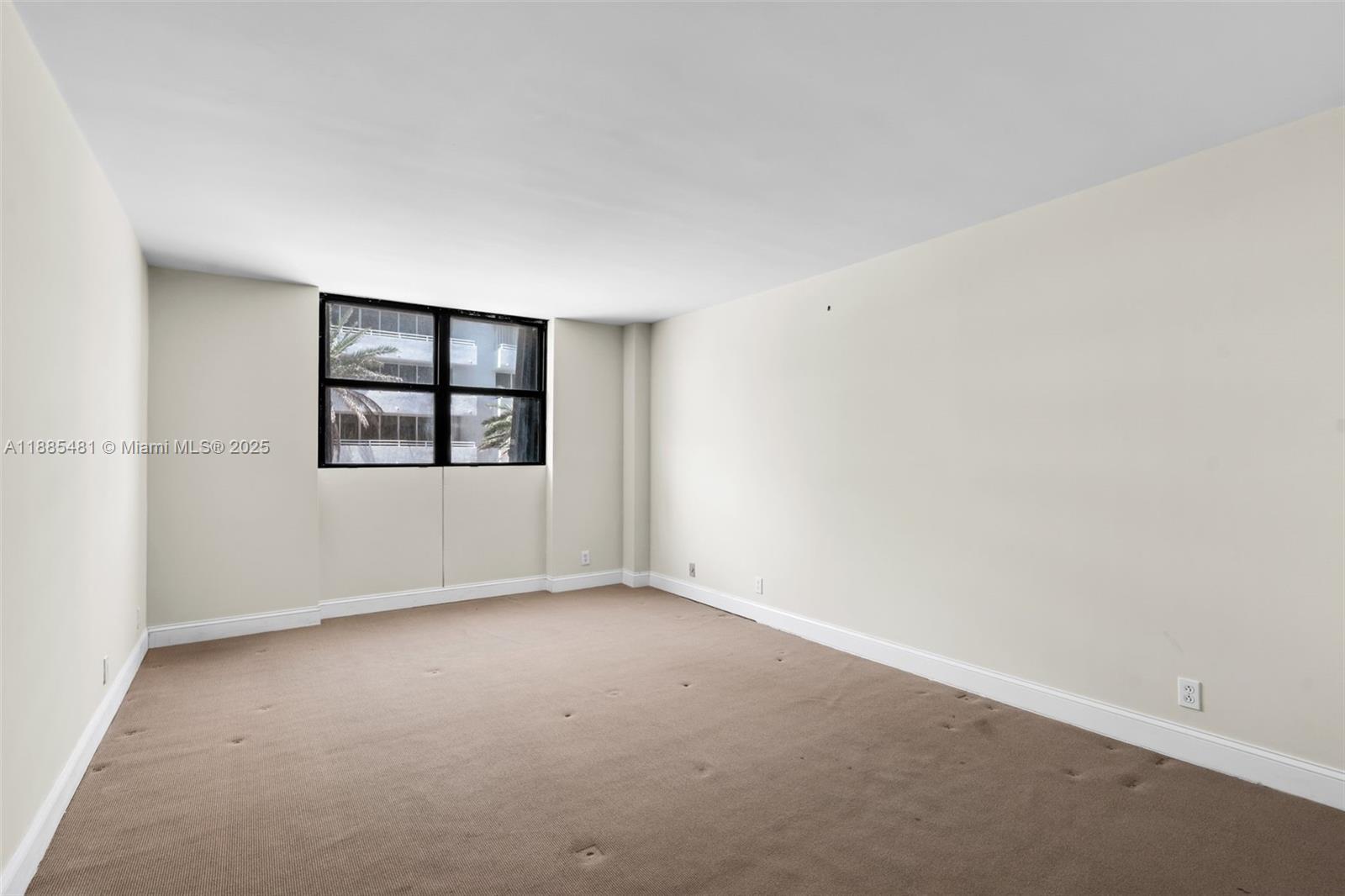 8877 Collins Avenue, Unit 303 Surfside, FL 33154 - Photo 13 of 25 an empty room with windows