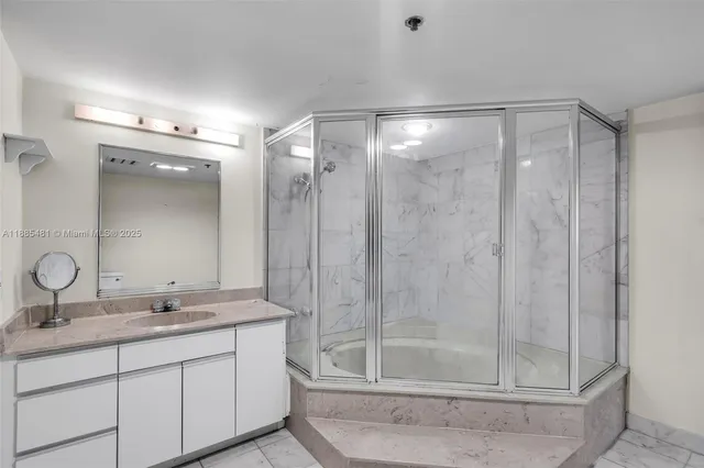 a bathroom with a shower sink and mirror