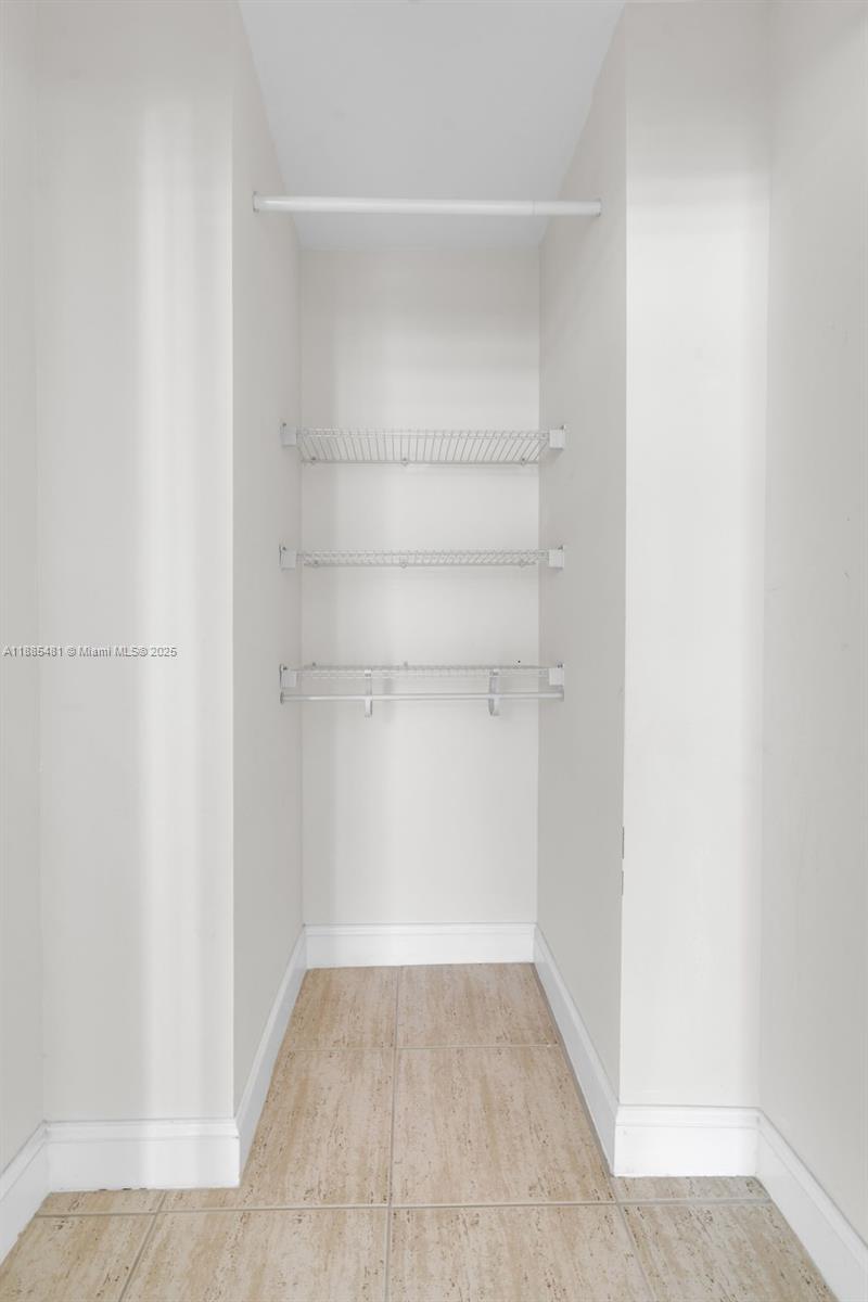 8877 Collins Avenue, Unit 303 Surfside, FL 33154 - Photo 20 of 25 a view of a room with shelf