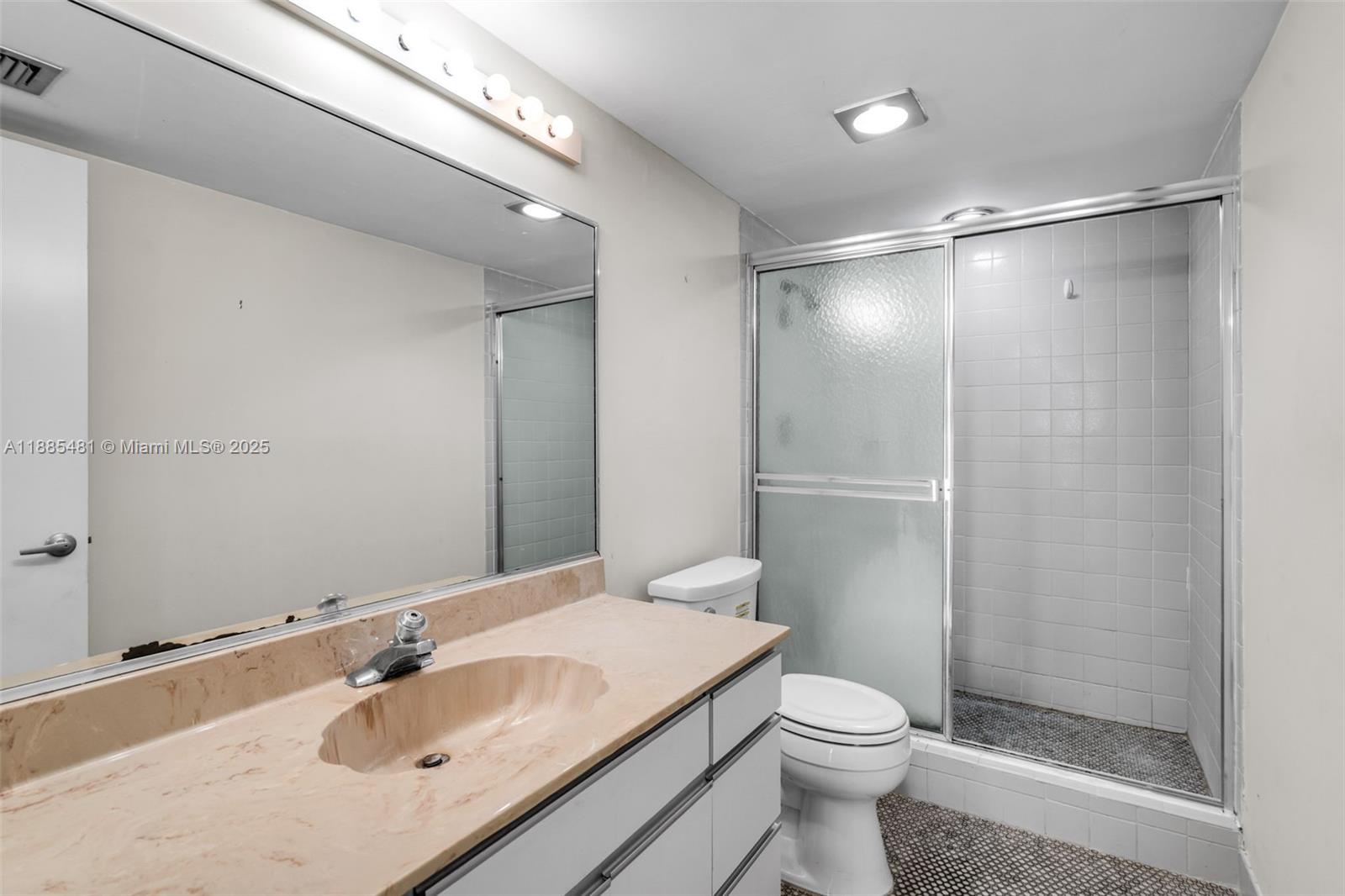 8877 Collins Avenue, Unit 303 Surfside, FL 33154 - Photo 21 of 25 a bathroom with a sink toilet and shower
