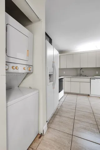 a kitchen with stainless steel appliances a refrigerator sink and cabinets