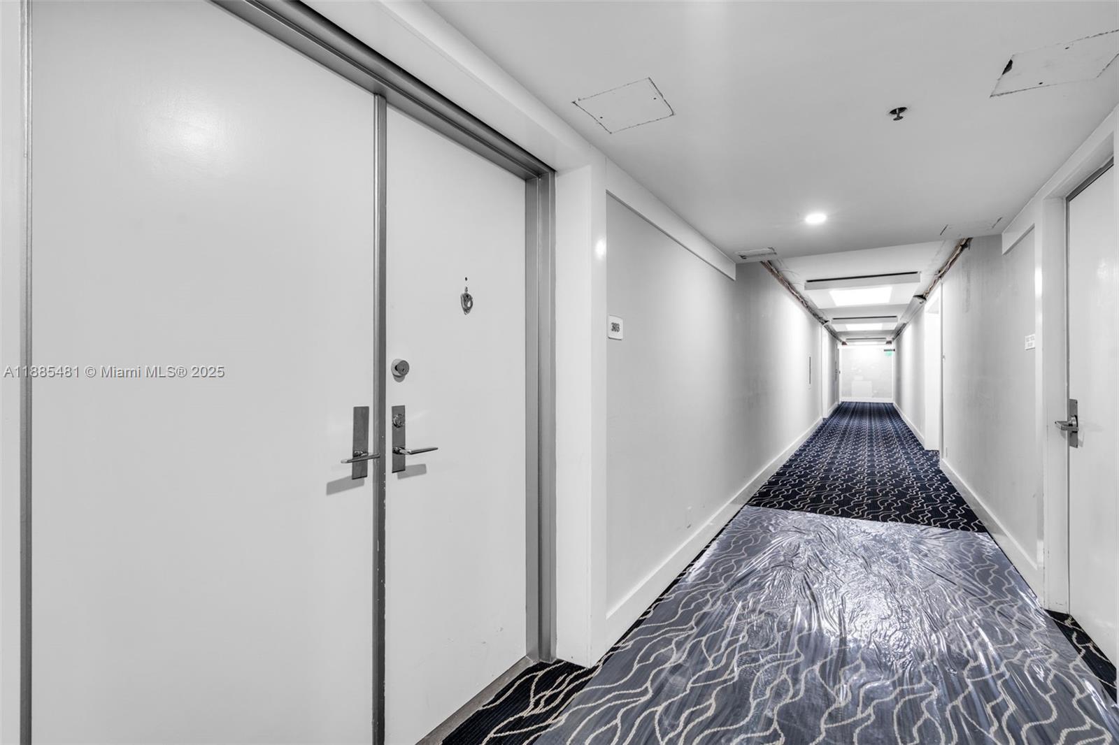 8877 Collins Avenue, Unit 303 Surfside, FL 33154 - Photo 6 of 25 a view of hallway with wooden floor