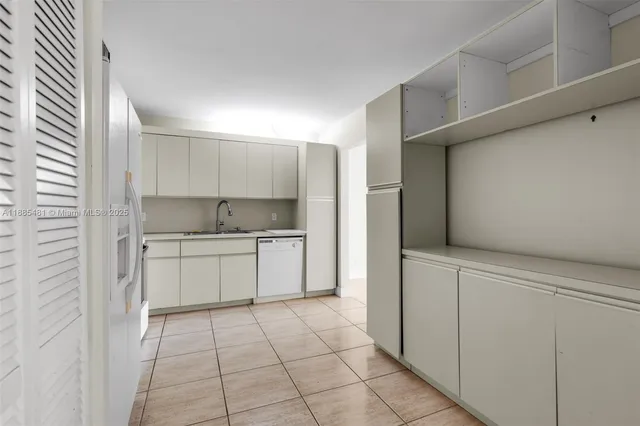 a kitchen with a stove top oven a sink and cabinets