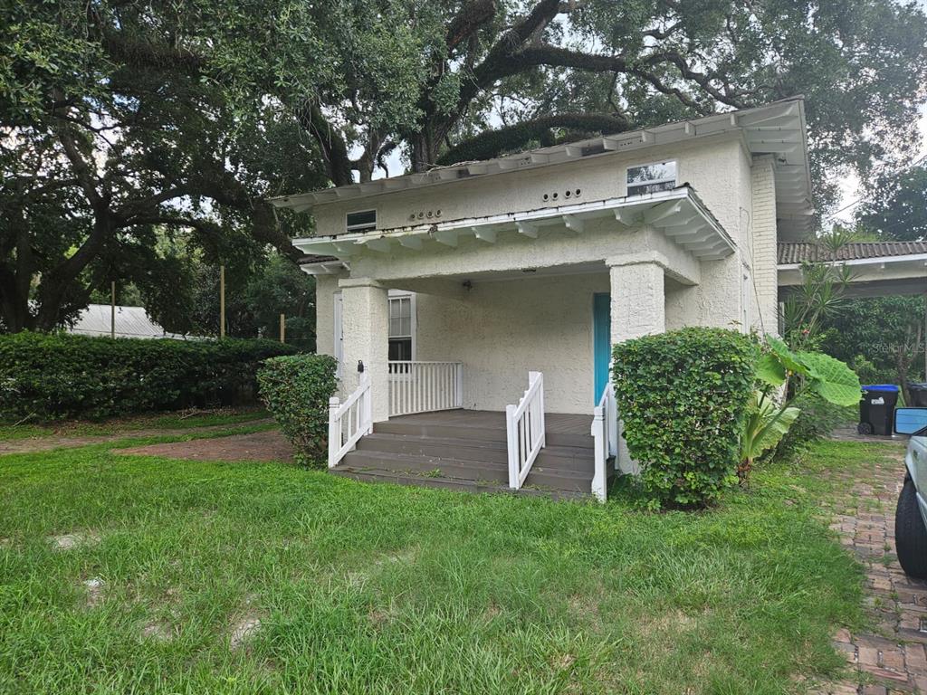 a view of a house with a yard and plants