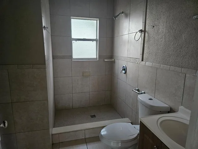 a bathroom with a toilet sink and shower
