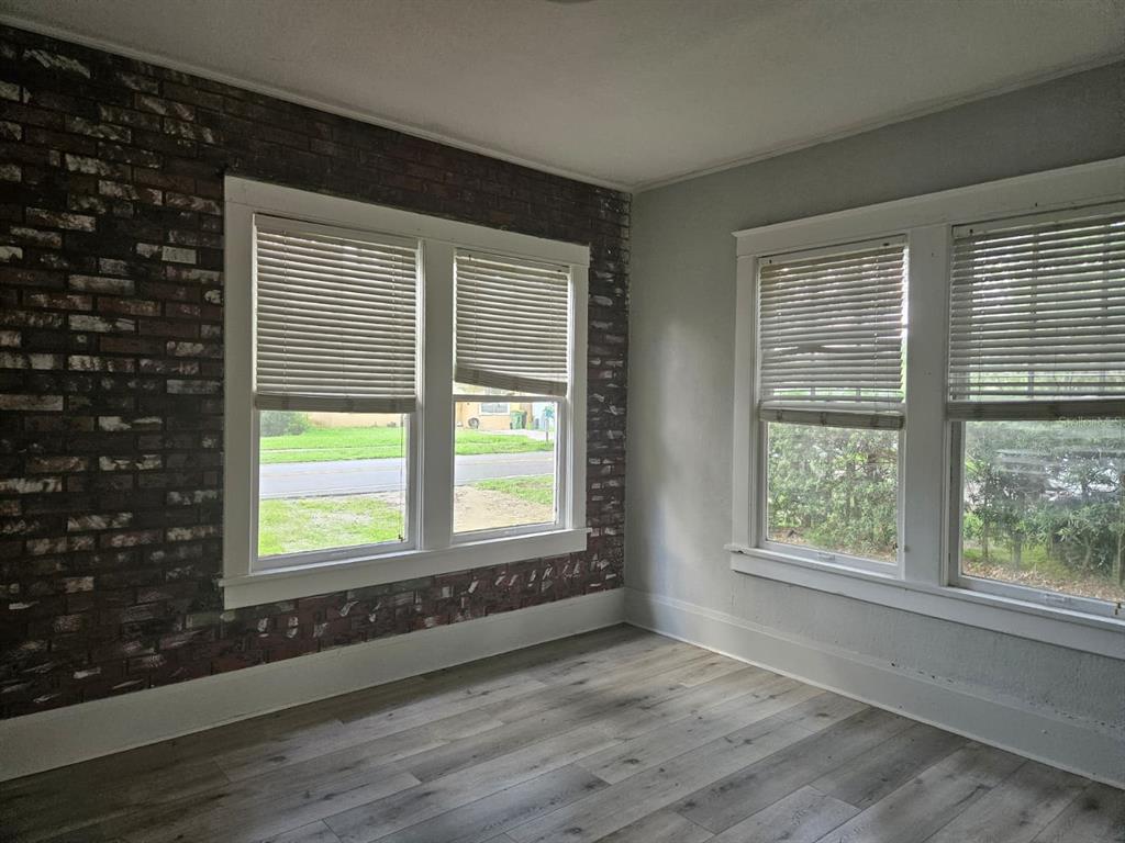 6404 Matchett Road Orlando, FL 32809 - Photo 12 of 20 an empty room with wooden floor and windows