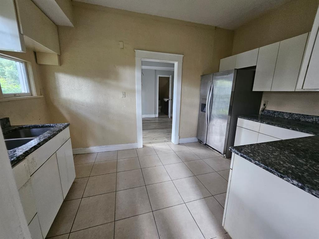 6404 Matchett Road Orlando, FL 32809 - Photo 4 of 20 a kitchen with a sink a stove and refrigerator