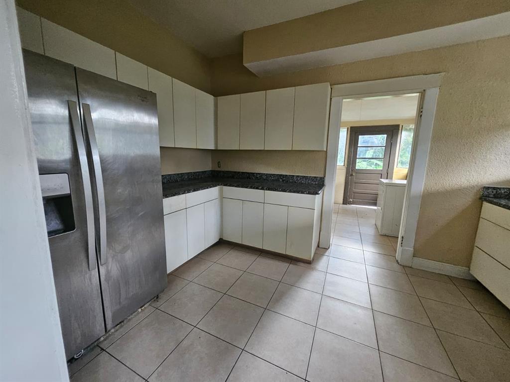 6404 Matchett Road Orlando, FL 32809 - Photo 6 of 20 a kitchen with stainless steel appliances granite countertop a refrigerator and a sink