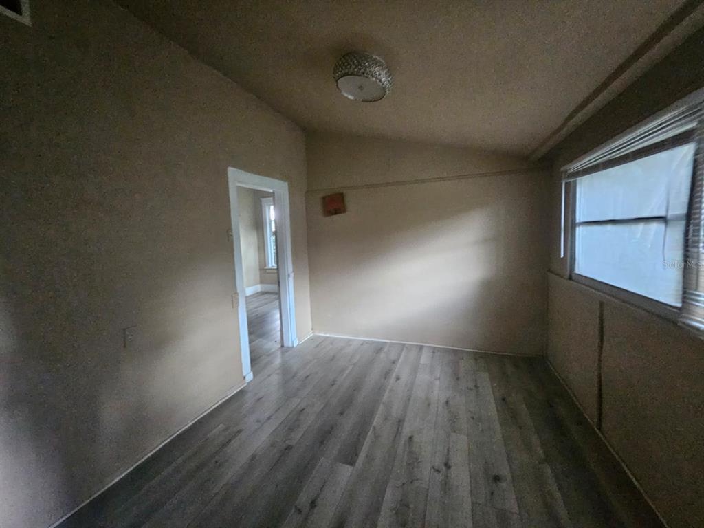 6404 Matchett Road Orlando, FL 32809 - Photo 8 of 20 a view of empty room with wooden floor and fan
