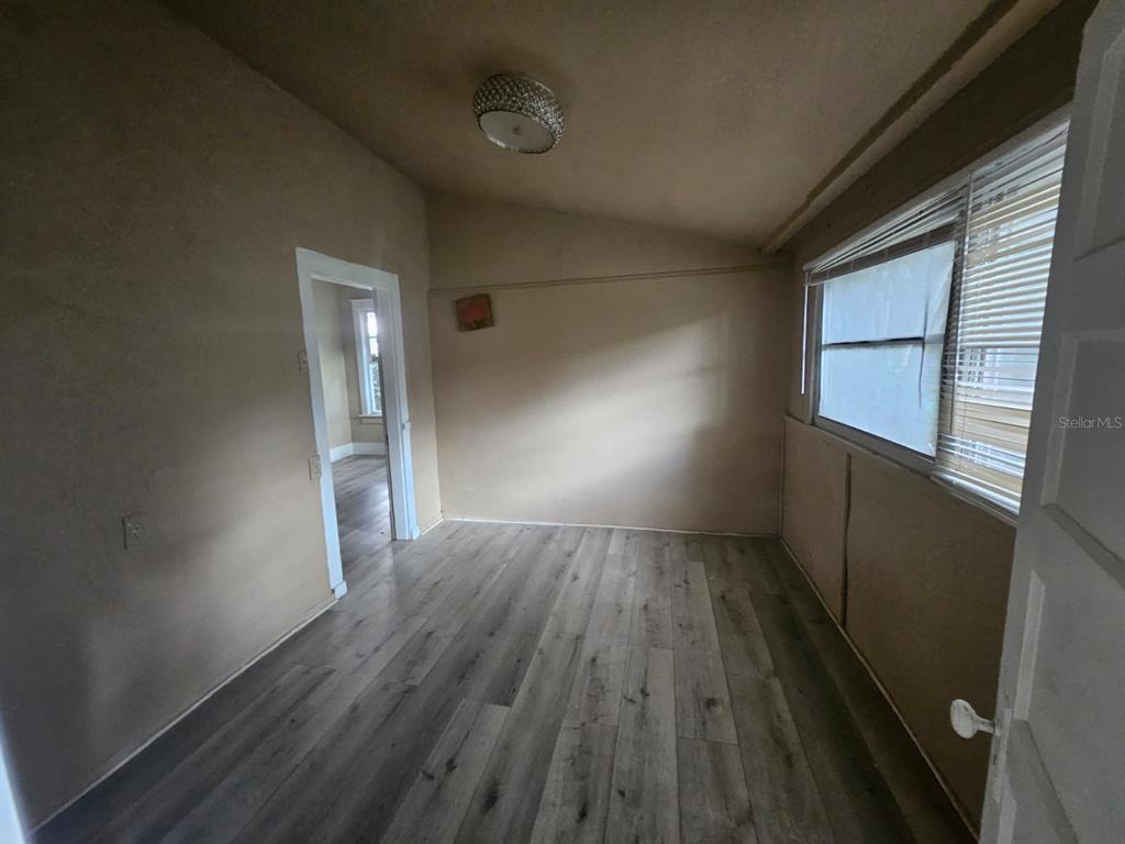 6404 Matchett Road Orlando, FL 32809 - Photo 9 of 20 a view of wooden floor and windows in an empty room