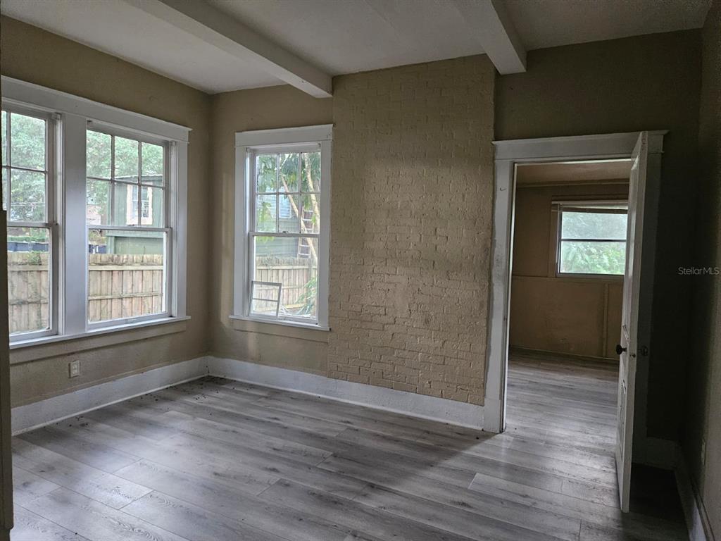 6404 Matchett Road Orlando, FL 32809 - Photo 10 of 20 a view of an empty room with wooden floor and a window