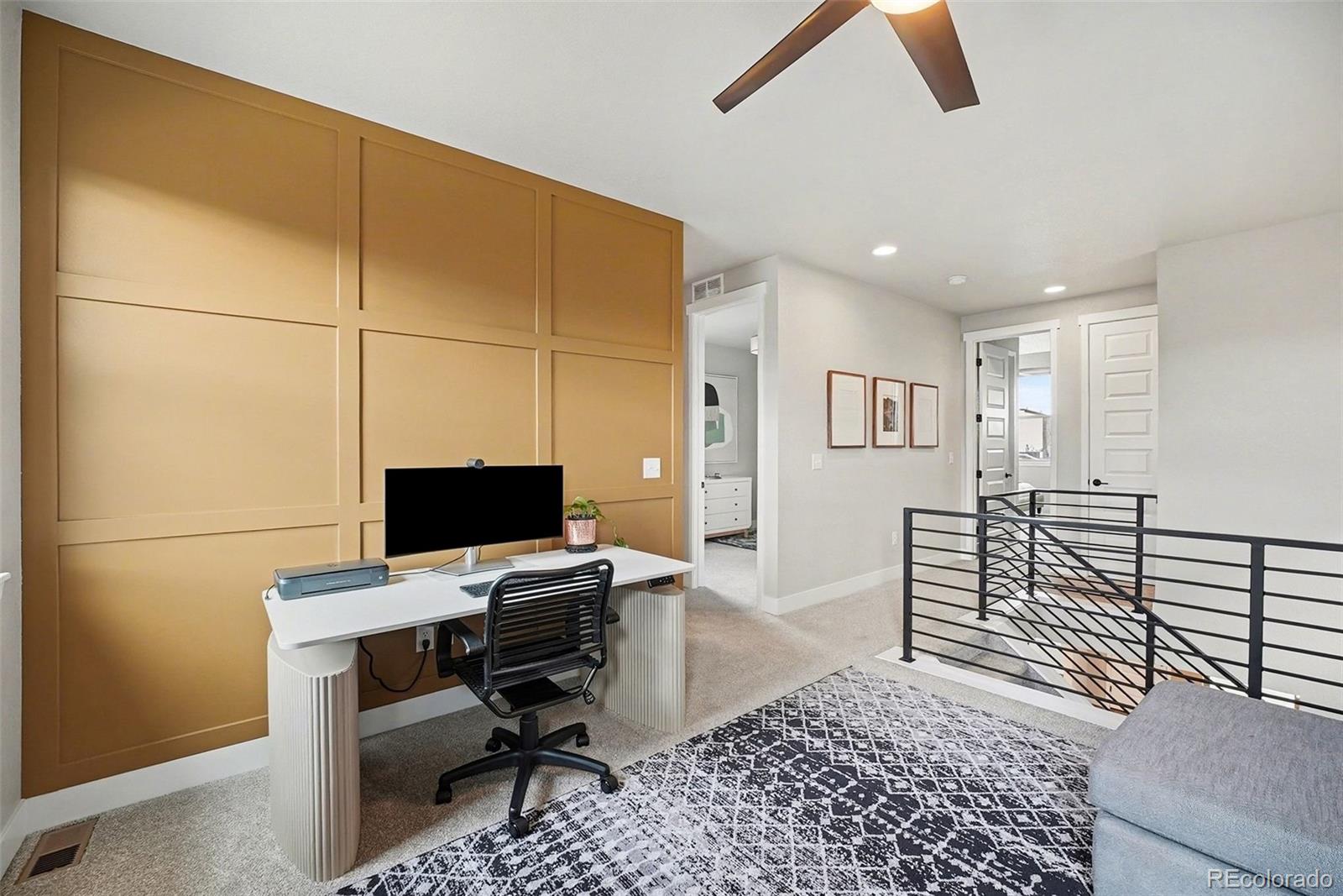 6793 Canosa Street Denver, CO 80221 - Photo 13 of 34 a workspace with wooden floor and furniture