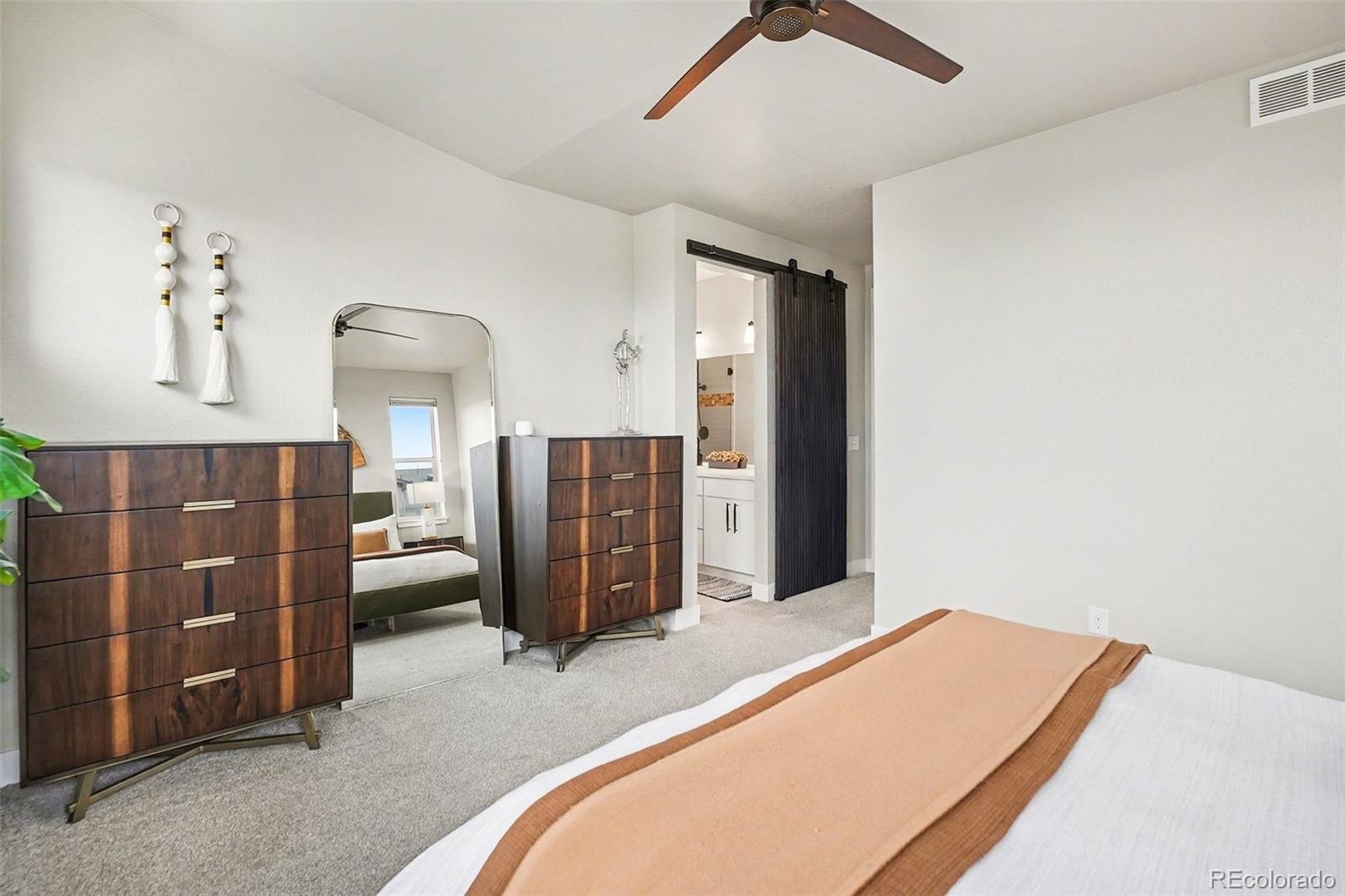 6793 Canosa Street Denver, CO 80221 - Photo 19 of 34 a bedroom with a bed dresser and window