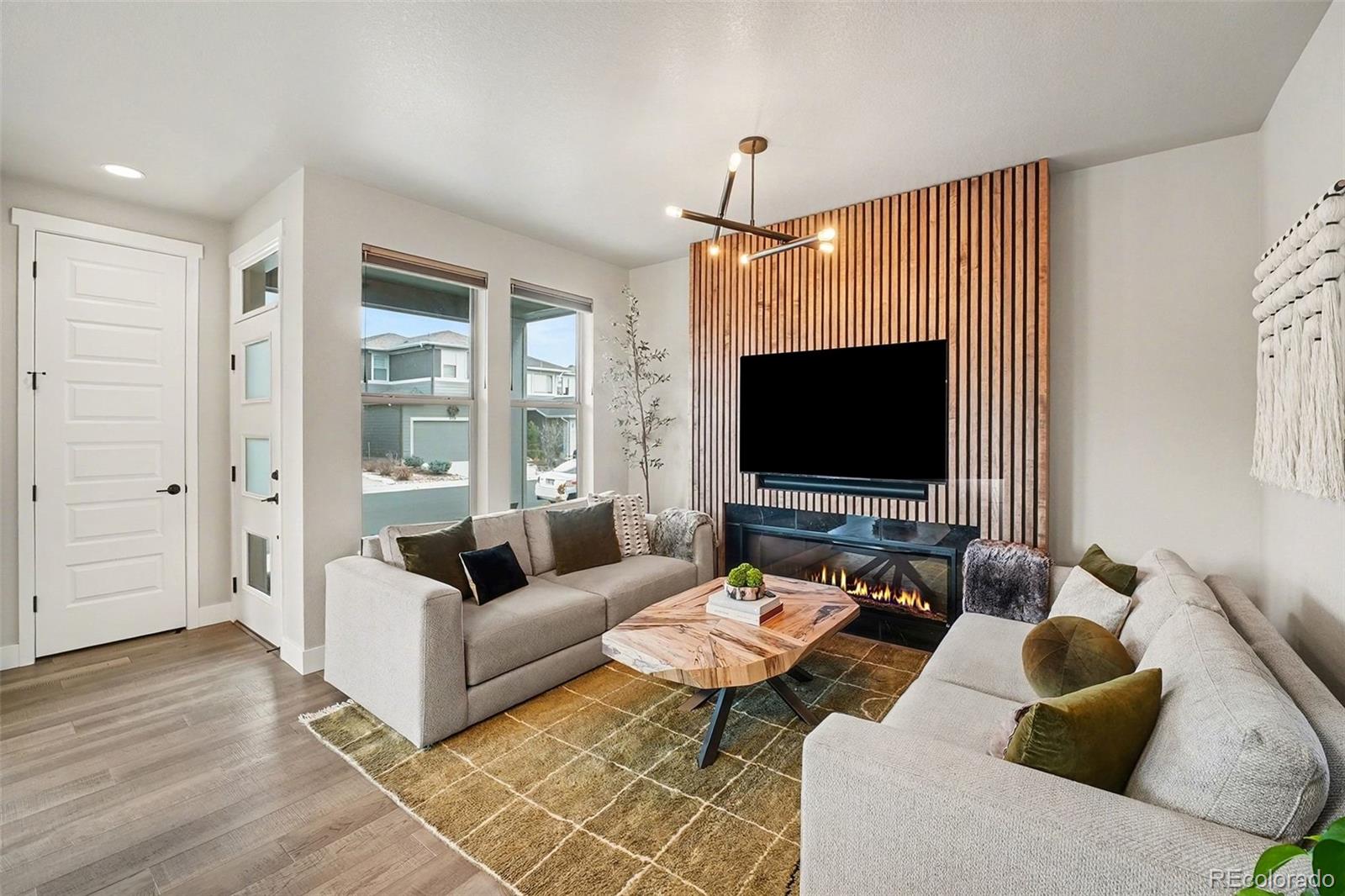 6793 Canosa Street Denver, CO 80221 - Photo 21 of 34 a living room with furniture and a flat screen tv