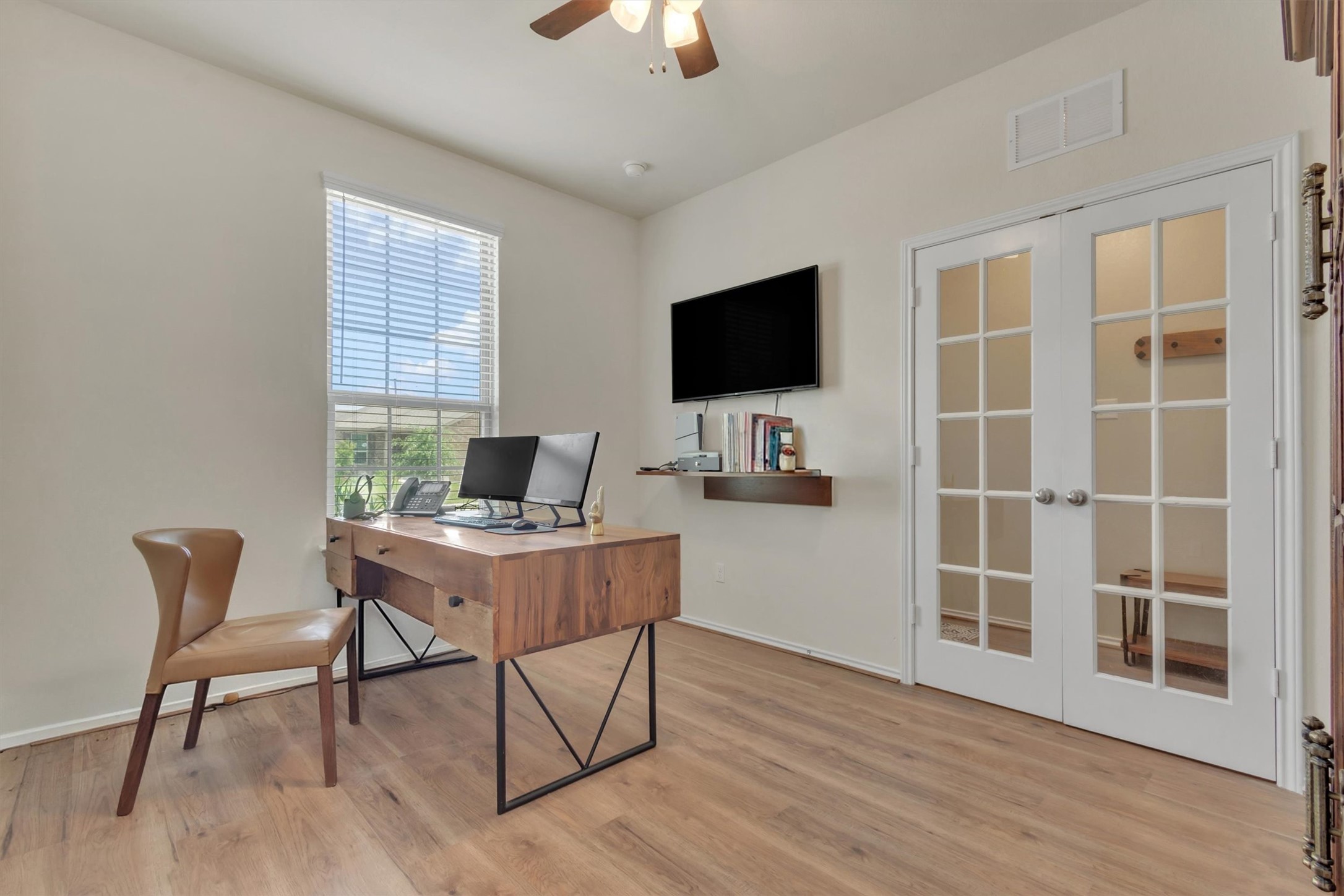 11701 Jackson Falls Way Manor, TX 78653 - Photo 6 of 40 A quiet study space with rich wood flooring and French doors offers an inspiring atmosphere for productivity.