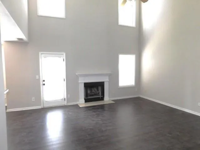 an empty room with wooden floor and a window
