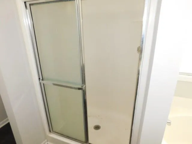 a bathroom with a glass shower door