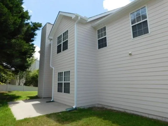 a view of backyard of house and trees