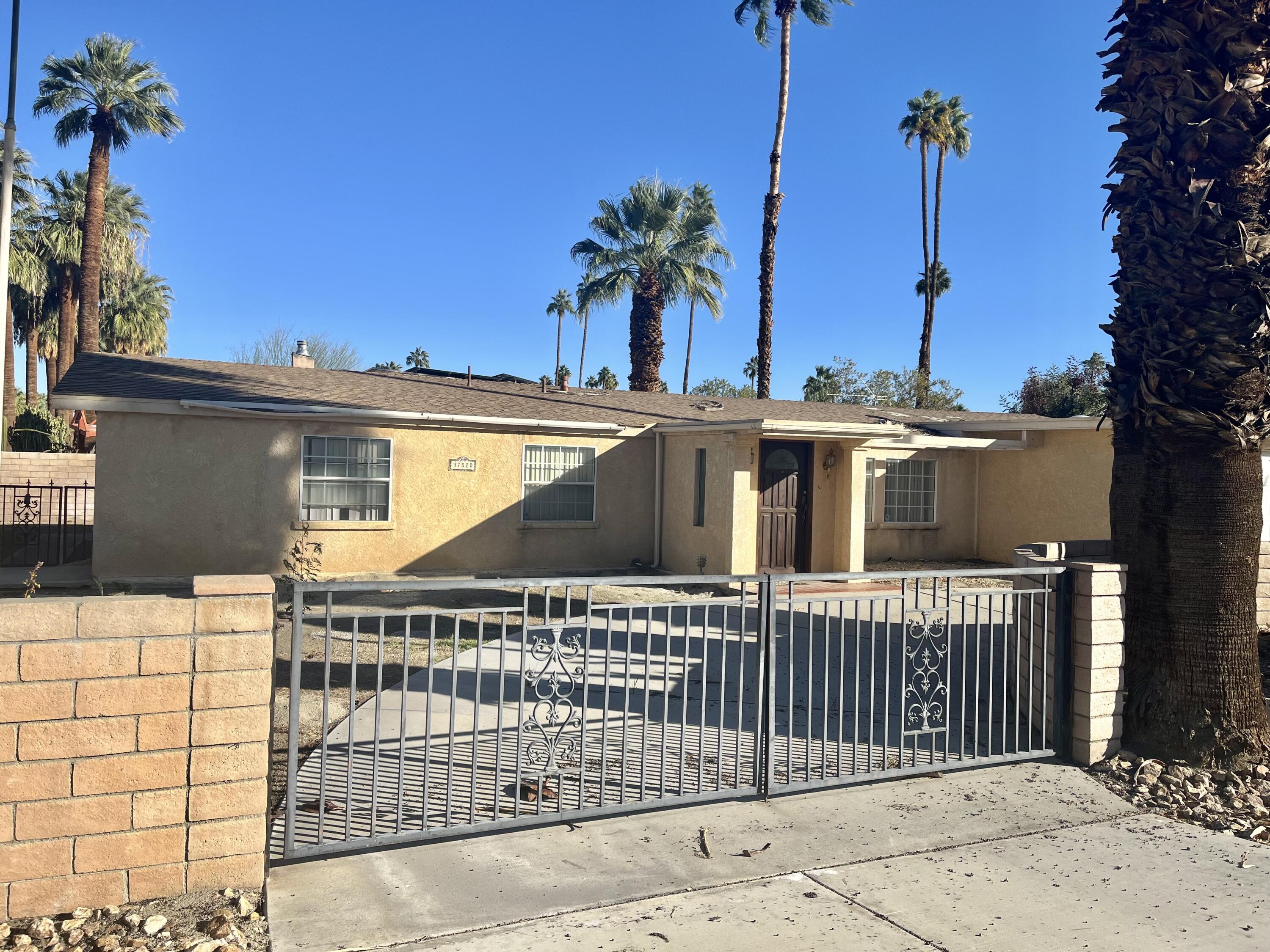 a view of a house with a small yard and plants