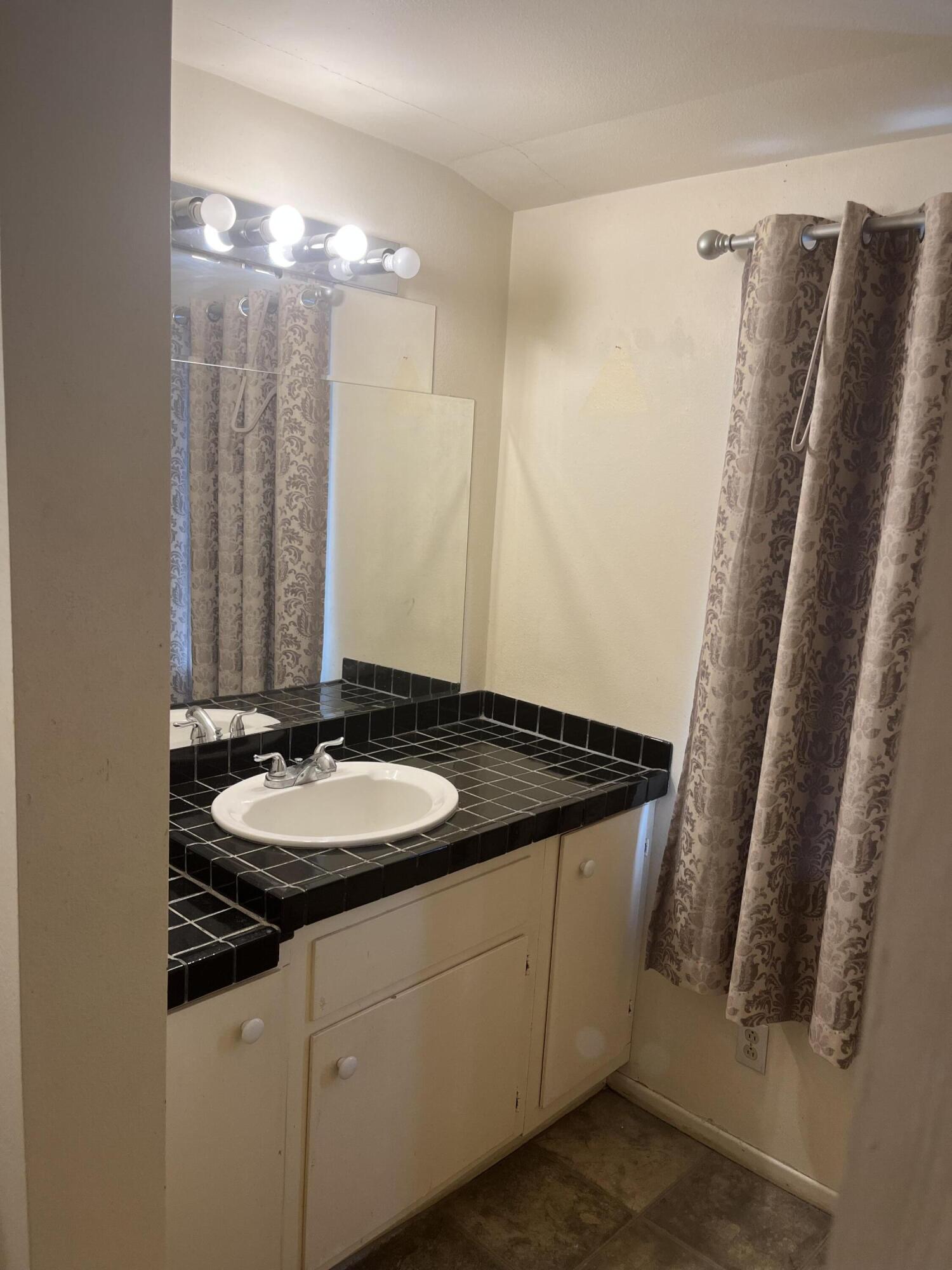 37520 Da Vall Drive Rancho Mirage, CA 92270 - Photo 15 of 23 a bathroom with a granite countertop sink and a mirror