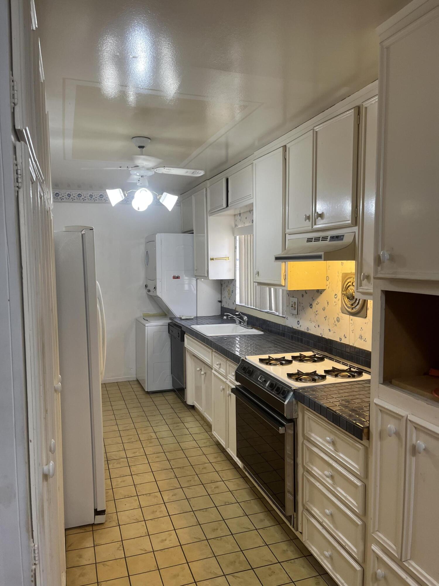 37520 Da Vall Drive Rancho Mirage, CA 92270 - Photo 10 of 23 a kitchen with stainless steel appliances granite countertop a stove a sink dishwasher and a refrigerator