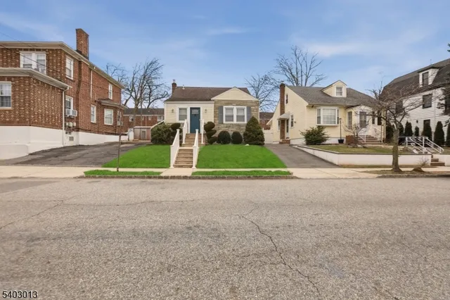 a view of multiple houses with a street