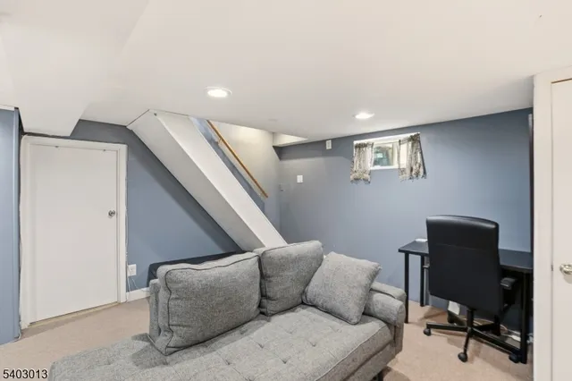 a living room with furniture and a piano
