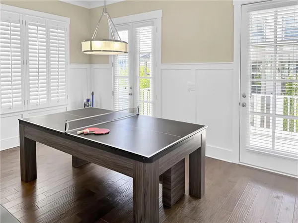 a room with pool table and windows