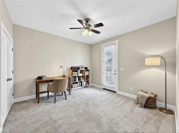 a living room with furniture and a floor to ceiling window