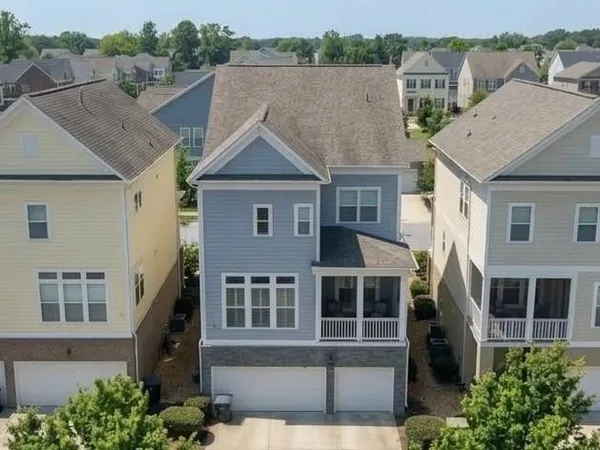 an aerial view of a house with a yard