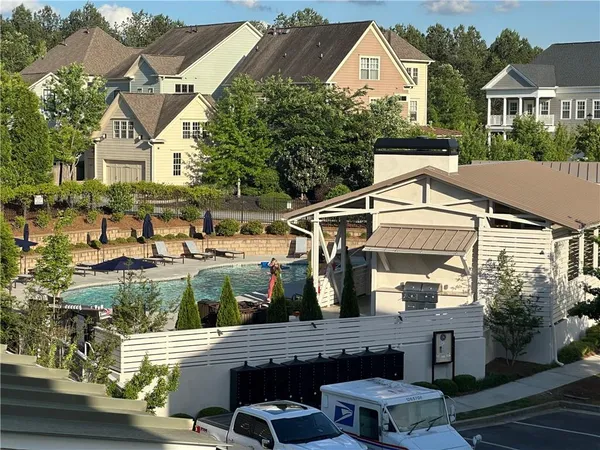 a view of a big yard with table and chairs under an umbrella