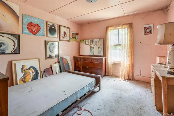 a spacious bedroom with a bed and a table in it