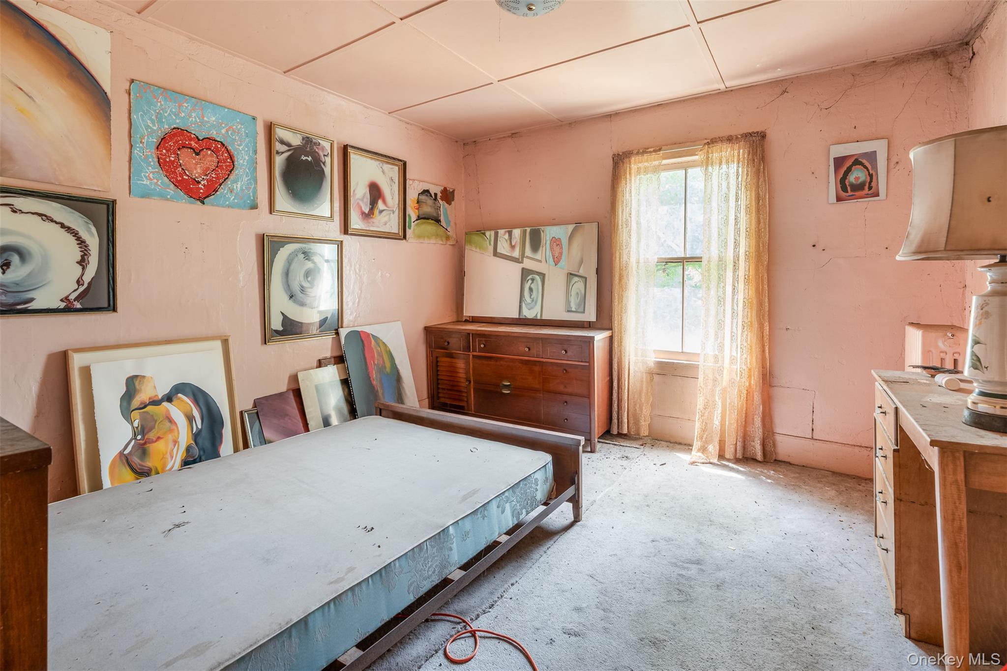50 Maple Street Catskill, NY 12414 - Photo 17 of 27 a spacious bedroom with a bed and a table in it