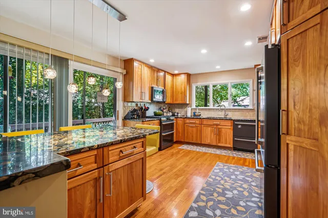 a living room with furniture rug and wooden floor