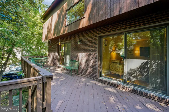 a spacious bedroom with a bed and a chandelier