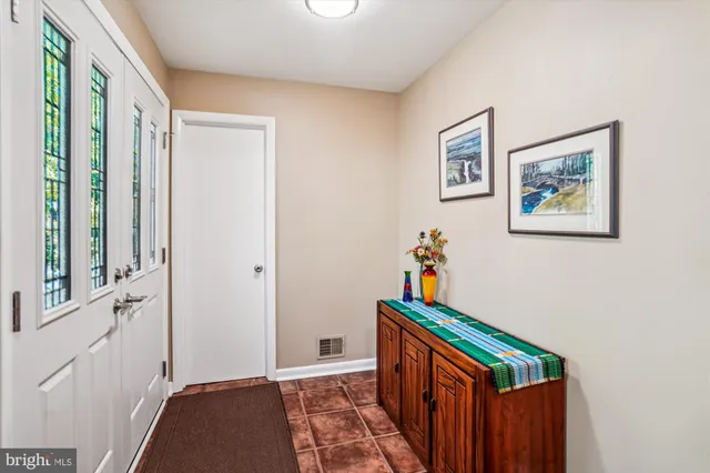 a living room with furniture fireplace and dining room