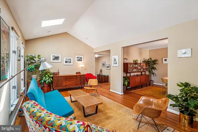 a living room with dining room and wooden floor