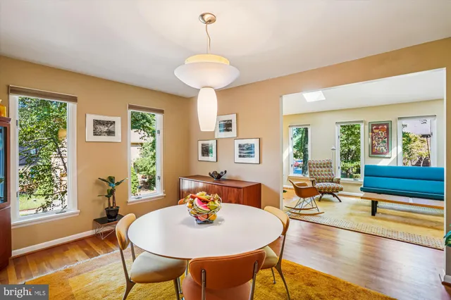 a dining room with furniture and a chandelier