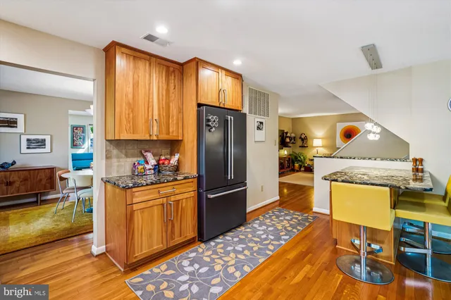 a kitchen with stainless steel appliances granite countertop wooden cabinets a stove top oven a sink and dishwasher